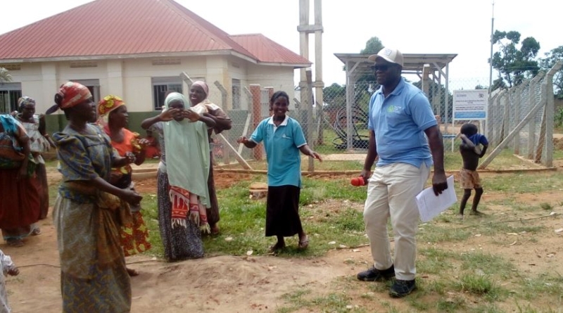 Country Director of Life Water International, Mr. Curuma Emmanuel dancing with community members 