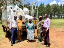 The District vice chairperson (blue dress) , Deputy RDC(left) with the principle Agric officer  receiving cuttings from supplier.